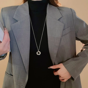Close-up of interlocking triple ring pendant necklace with zircon on a fashion model