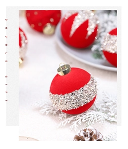 Close-up of red velvet Christmas ball ornament with sparkling gold sequins and beads
