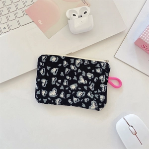 Close-up of leopard heart print mini pouch with pink lanyard on a clean desk
