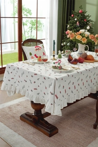 Close-up of cotton Christmas tablecloth with red berry embroidery and ruffle edges