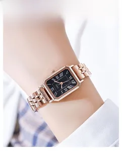 Close-up of elegant square watch with black dial and rose gold metal bracelet