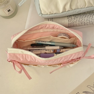 Macro shot of large capacity pink canvas pencil case with interior organizer compartments