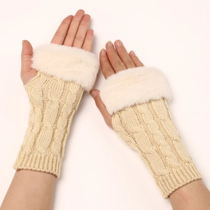 Detail of twisted knit gloves with faux fur trim showing soft texture and warm wrist cuff
