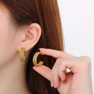 French vintage gold twisted C-shape stainless steel earrings shown on a model