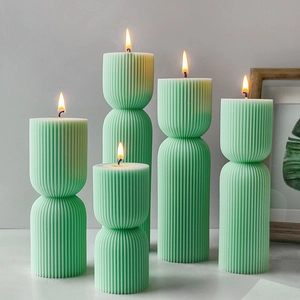 Striped cylindrical aromatherapy candle set with mint green fluted pillar design