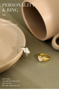 Close-up of S925 sterling silver heart rings with white shell inlay in gold and silver