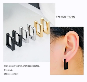 Detail view of geometric stainless steel hoop earrings in black, silver, and gold finishes