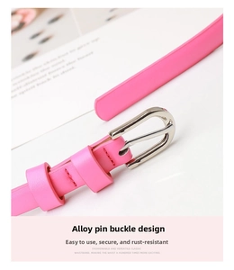 Close-up of pink leather skinny belt featuring a silver alloy buckle and neat edge stitching