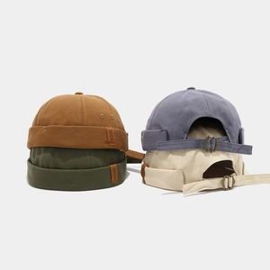 Detail of miki hats showing thick canvas texture and adjustable metal buckle straps