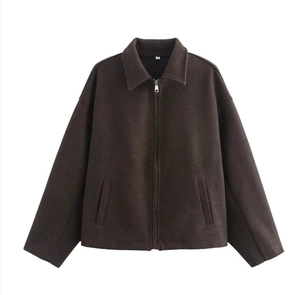 Close-up of brown zipper jacket collar with size M label on textured felt fabric