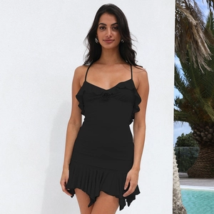 Detail of black V-neck mini dress featuring ruffled hem and decorative floral appliqué