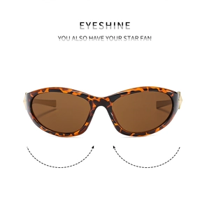 Detail of vintage Y2K tortoiseshell sunglasses with brown lenses and golden accents