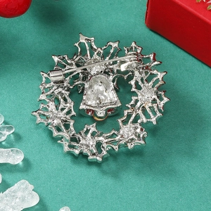 Detail of silver Christmas wreath brooch showing secure pin fastener on the back