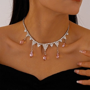 Silver necklace with pink teardrop crystals and zircons shown on a female model