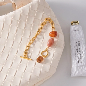 Detail of vintage gold chain bracelet with marble resin beads and OT toggle clasp