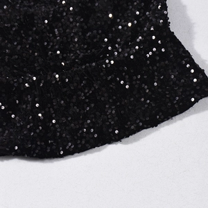 Close-up of black sequins texture and elastic pleated hem on a stylish crop top
