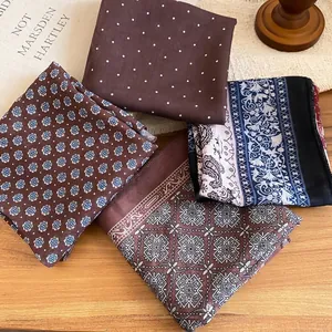 Retro paisley fabric scarf necklaces with vintage prints displayed on a wooden surface