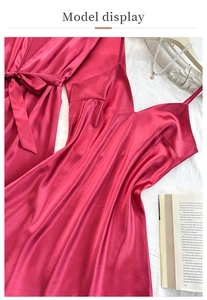 Flat lay of wine red silk satin robe and slip dress set with elegant pearl accessories