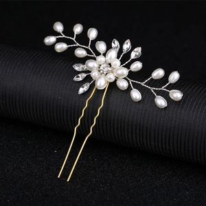 Detail of bridal hair pin with handmade pearls, crystals, and gold wire floral design