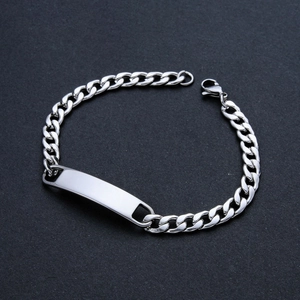 Detailed close-up of a polished stainless steel Cuban link bracelet with blank ID plate