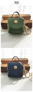 Detailed macro view of mini PU leather keychains with wavy stitching and gold clasps