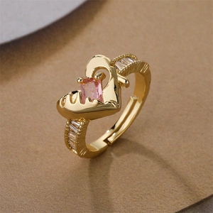 Detail of gold-plated heart ring with pink rectangular stone and adjustable band