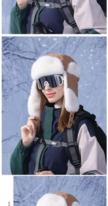 Detail of plush winter trapper hat with snow goggles and outdoor windproof jacket