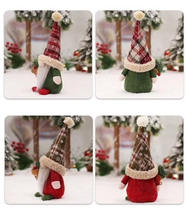 Detail view of red and green plaid Nordic Christmas gnomes with knit hats in a snow scene