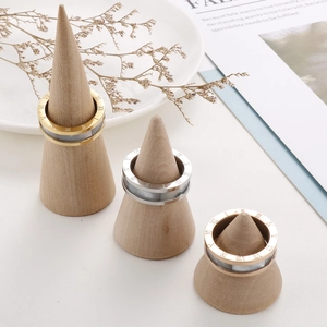 Three-color roman numeral rings in gold silver and rose gold on wooden display stands