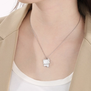 Silver necklace with a cute cat pendant and white shell inlay worn by a female model