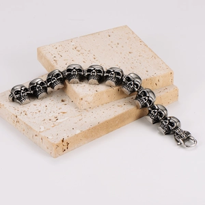 Gothic skull link bracelet in vintage stainless steel finish on travertine stone