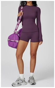 Détail d'un ensemble de yoga violet foncé avec haut à col montant et short de cyclisme