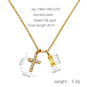 Detailed view of 18K gold plated necklace with zircon cross and yellow gemstone pendants
