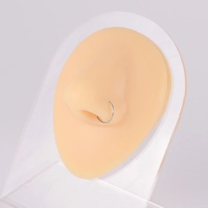 Minimalist silver G23 titanium fake nose ring shown on realistic silicone nose model