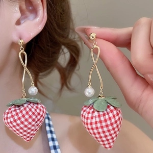 Detail of strawberry drop earrings with red checkered fabric and pearl accent