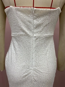 Close-up of white sequin dress featuring a high-quality invisible back zipper detail