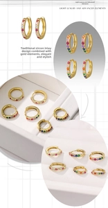 Macro shot of 18K gold hoop earrings featuring multi-color rainbow cubic zirconia stones