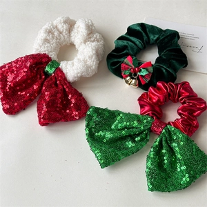 Detailed view of Christmas scrunchies with sequin bows, bells and soft plush textures