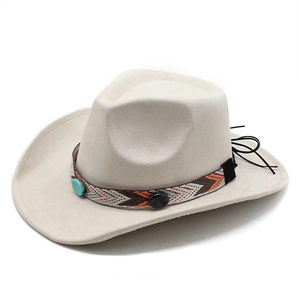 Detail of beige suede fedora featuring geometric ethnic band and turquoise decorative studs