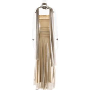 Detailed view of champagne gold evening dress with shimmering fabric and matching scarf