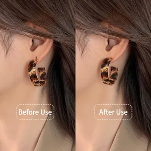 Silicone earring support patches showing before and after effect on heavy earrings