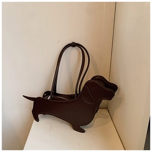 Detail of dachshund-shaped handbag in dark coffee faux leather with zipper closure