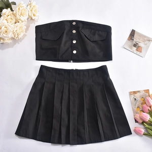 Flat lay of a black strapless tube top with buttons and a pleated mini skirt set