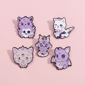 Set of 5 purple enamel cat skull pins with moon and bat motifs on pink background