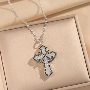 Cross necklace with black and white cubic zirconia inlay in a champagne gift box