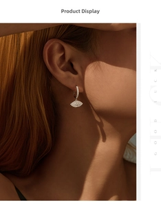 Detailed view of S925 sterling silver evil eye hoop earrings with sparkling zircon