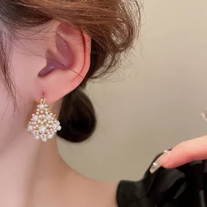 French style gold plated pearl cluster drop earrings shown on a model for elegant look