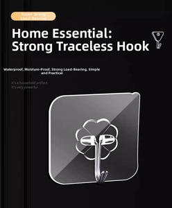 Close-up of a strong transparent adhesive wall hook with a metal hook and clover base