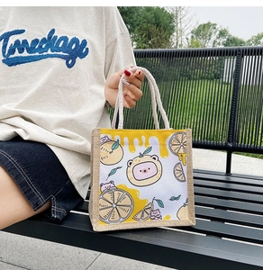 Detail of cute cartoon bear print on canvas tote bag with thick cotton rope handles