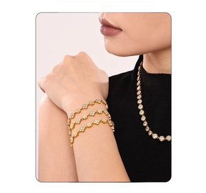 Close-up of 18k gold plated flower bracelet and necklace set with inlaid zircon accents